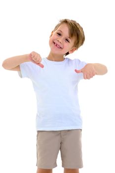 Happy boy giving thumbs up. Cheerful little boy wearing white t-shirt and beige shorts posing against white background. Portrait of smiling six years old kid