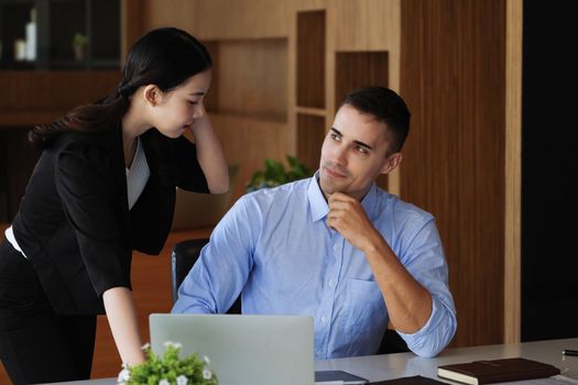 The male marketing manager expressed his satisfaction in selling the company's products. where team members show sales from their iPad screen