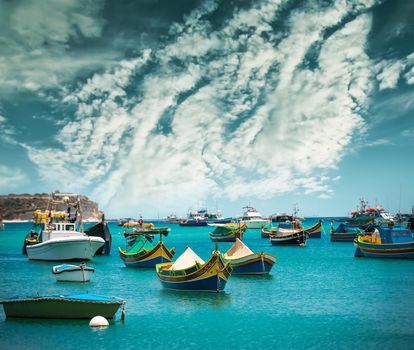 fishing boats near fishing village of Marsaxlokk (Marsascala) in Malta against sky
