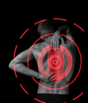 Man is touching the back, concept of pain in the spine, monochrome image, pain area of red color