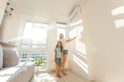 mother and daughter hangs a large photo canvas at home