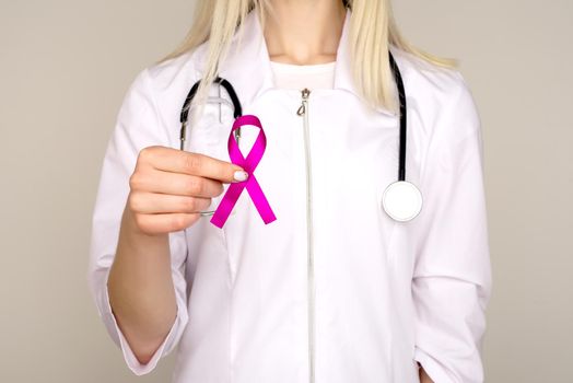 Female Doctor Holds Pink Ribbon, International Breast Cancer Day October 7 - Image