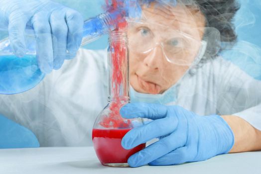 Mad scientist is pouring chemical liquid into laboratory tube