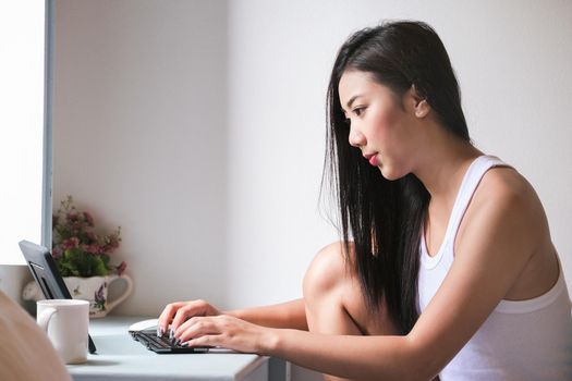 new normal, a businesswoman using computer to work for a company Via the internet on your desk at home