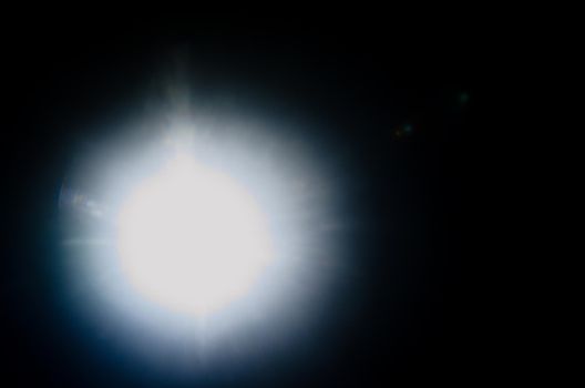 Abstract Natural Sun flare or Far star on the black background - image