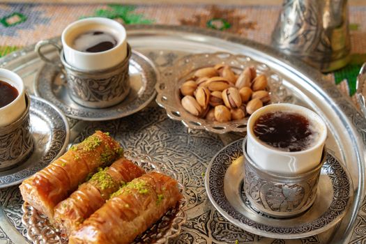 Traditional arabic dessert baklava with a cup of turkish coffee, close up