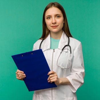 Happy smiling young female doctor with clipboard, isolated over background - image