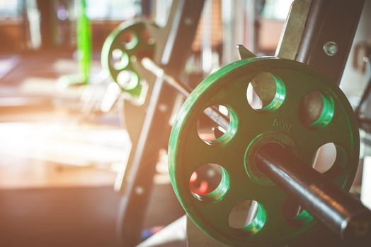 Rod with weights in the gym