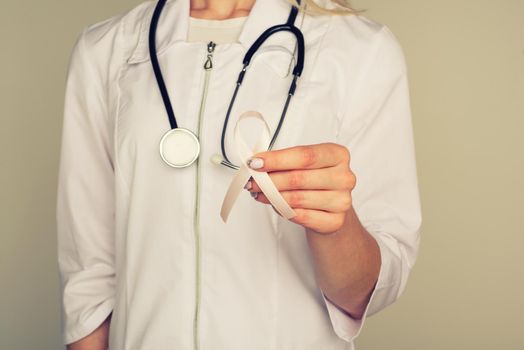 Female doctor in white uniform with ribbon - Image