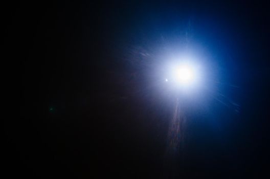Abstract Natural Sun flare or Far star on the black background - image