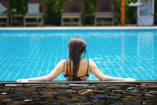 Beautiful southeast asia woman in pool relaxing