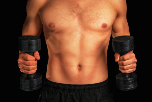 Unrecognizable strong man is lifting metal dumbbells