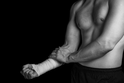 Pain in a male wrist, bandaged hand, monochrome image