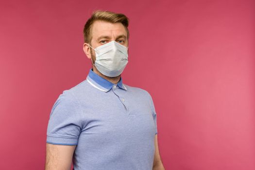 Protection against contagious disease, coronavirus. Man wearing hygienic mask to prevent infection, airborne respiratory illness such as flu, 2019-nCoV. indoor studio shot isolated on red background