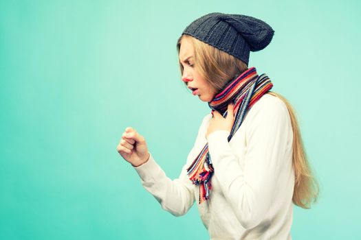 The girl has symptoms of coronavirus. Cold And Flu. Portrait Of Beautiful Teen Girl With Cough And Sore Throat Feeling Sick Indoors. Closeup Of Ill Unhealthy Woman Coughing