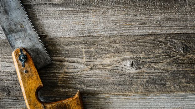 old saw on rustic wooden table