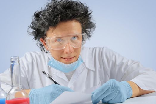 Happy crazy scientist writes laboratory records