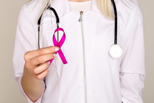 Female Doctor Holds Pink Ribbon, International Breast Cancer Day October 7 - Image