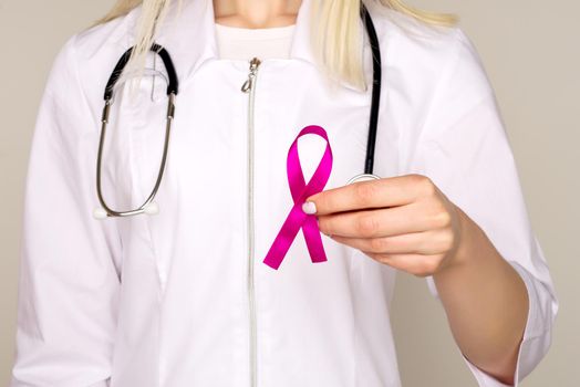 Female Doctor Holds Pink Ribbon, International Breast Cancer Day October 7 - Image