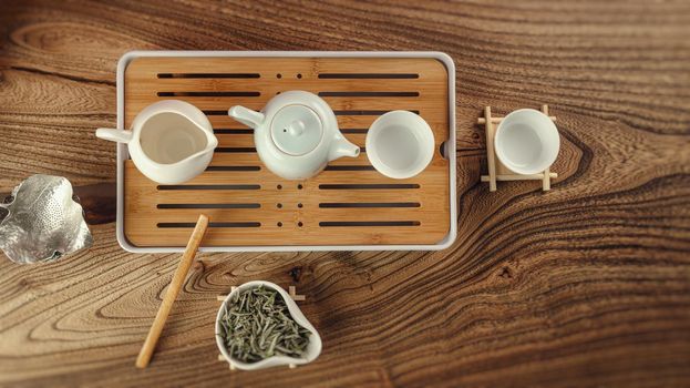 tea table with instruments teapots cups and green tea