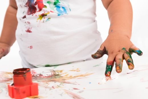 painted child's hand and colors isolated on white background