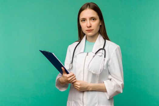 Happy smiling young female doctor with clipboard, isolated over background - image