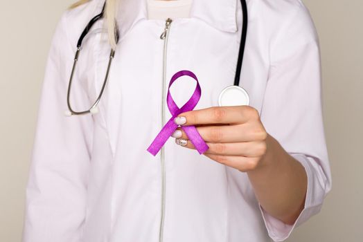 Female doctor in white uniform with purple awareness of ribbon in hand for ADD,ADHD,Alzheimer Disease ,Arnold Chiari Malformation,Childhood Hemiplegia stroke, Epilepsy, Chronic Acute Pain,Crohns - Image