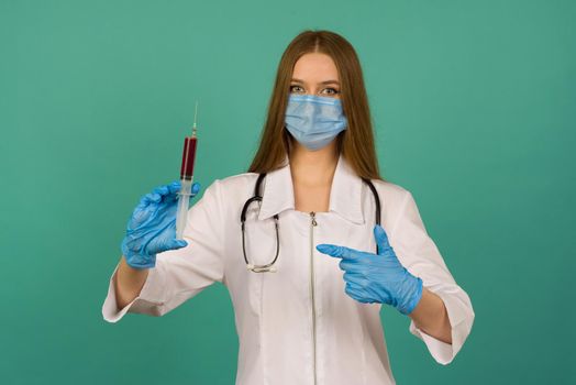 Covid19, coronavirus. Portrait of professional confident young caucasian doctor in medical mask and white coat, stethoscope over neck,with vaccine syringe in hand, fight disease - image