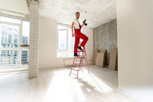 Electrician working with wires in new apartment