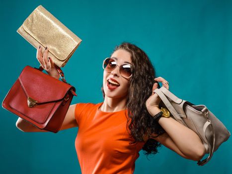 Fashion woman portrait isolated. Happy girl hold bags. Red dress. female beautiful model.