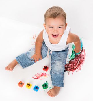 smiling little boy and gouache above photo on white background