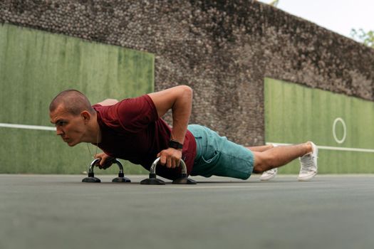 man doing push-ups on the court. bali