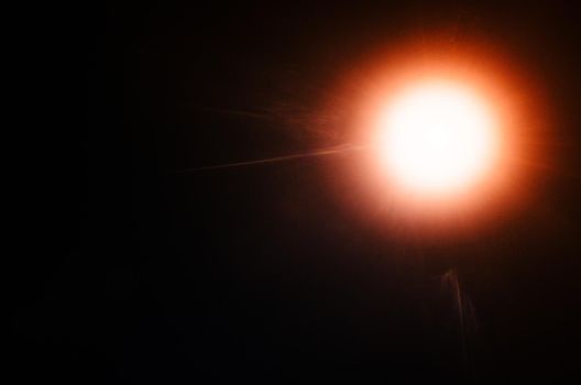 Abstract Natural Sun flare or Far star on the black background - image
