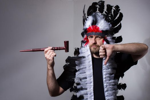 Man in Indian suit with a pipe in his hand shows that smoking is bad.Concept photo