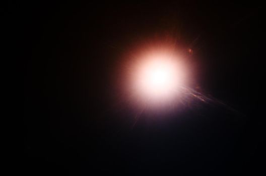 Abstract Natural Sun flare or Far star on the black background - image