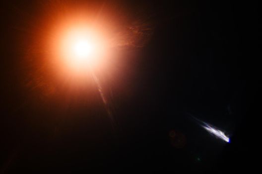 Abstract Natural Sun flare or Far star on the black background - image