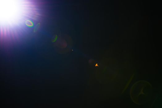 Flash of a distant abstract star. Abstract sun flare. The lens flare is subject to digital correction. - Image