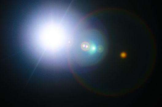 Abstract Natural Sun flare or Far star on the black background - image