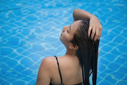 Beautiful southeast asia woman in pool relaxing