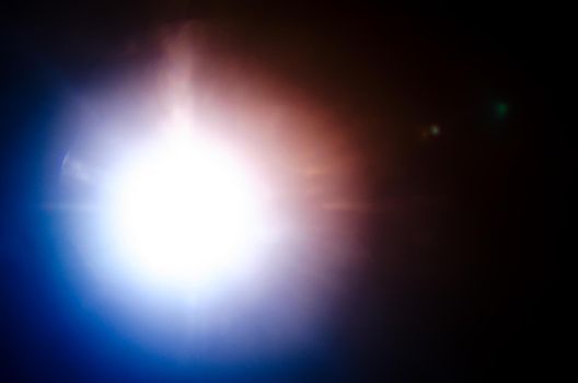 Abstract Natural Sun flare or Far star on the black background - image