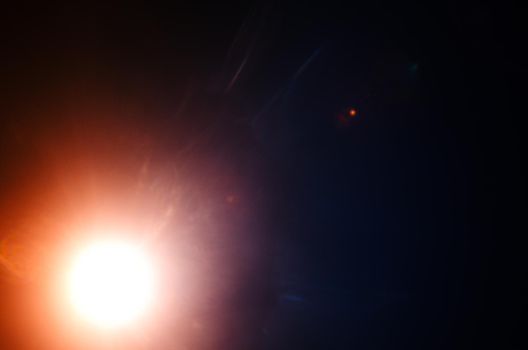 Abstract Natural Sun flare or Far star on the black background - image