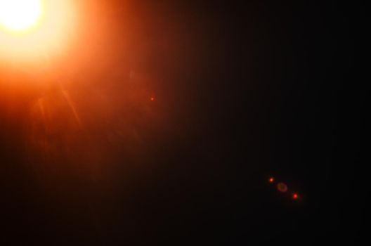 Abstract Natural Sun flare or Far star on the black background - image