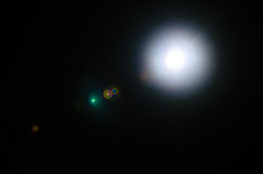 Abstract Natural Sun flare or Far star on the black background - image