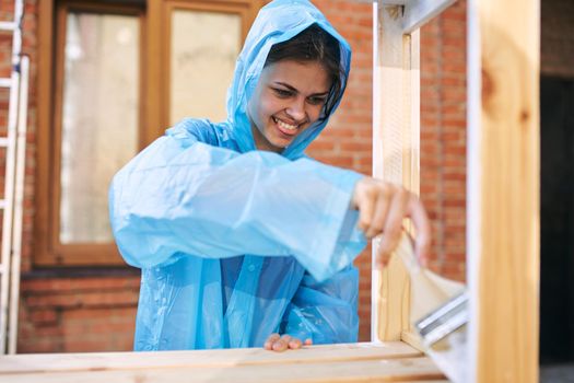 woman paints wood painter repair protective suit. High quality photo