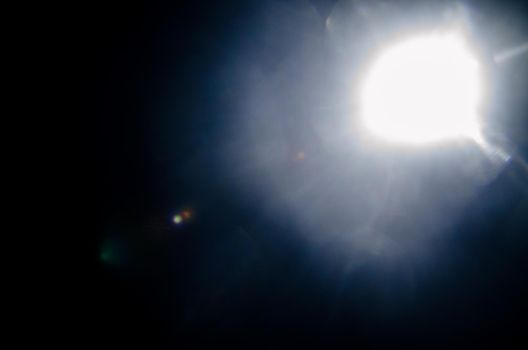 Abstract Natural Sun flare or Far star on the black background - image