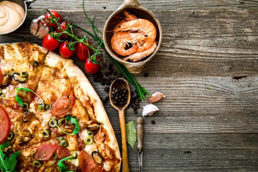 delicious pizza with seafood on wooden table
