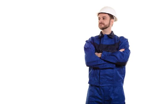 Handsome young man with protective helmet on his head and arms crossed, isolated on white background with copyspase