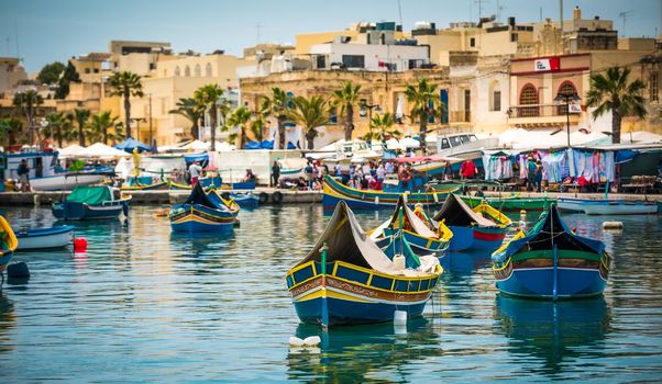 traditional fishing boats near market in fishing village of Marsaxlokk (Marsascala)