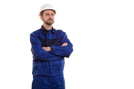 male construction worker in a helmet stands with his arms crossed isolated on white