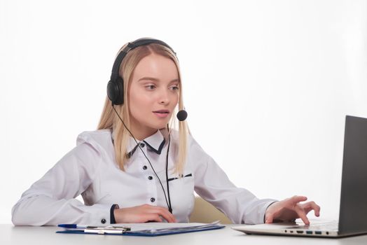 Portrait of happy smiling female customer support phone operator at workplace. - Image